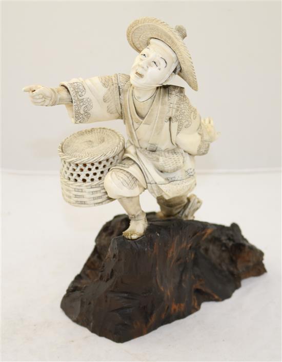 A Japanese sectional ivory figure of a fisherman, Meiji period, height 26.8cm, rod lacking